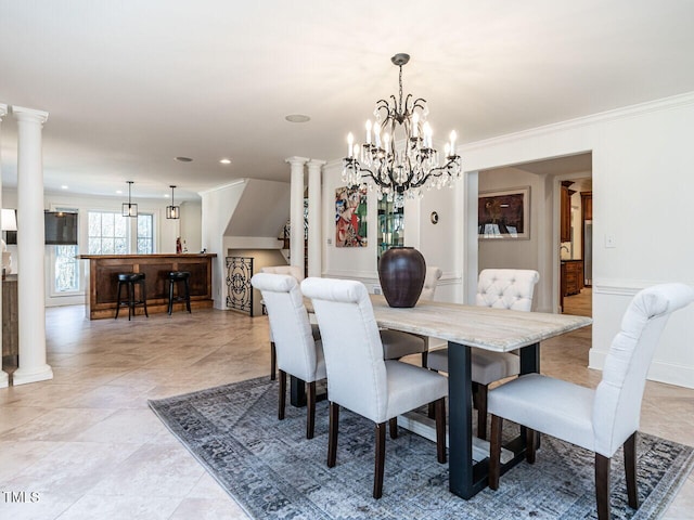 dining room featuring crown molding, light tile patterned flooring, and decorative columns