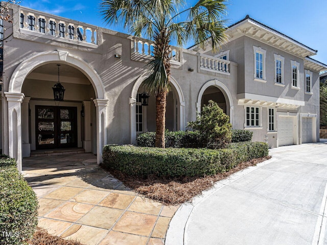 view of front of property featuring a garage and french doors