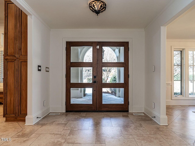 entryway featuring ornamental molding and french doors