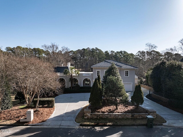 mediterranean / spanish-style house with a garage