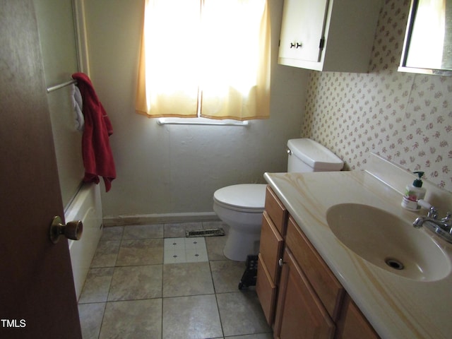 full bathroom with toilet, tile patterned flooring, baseboards, and vanity