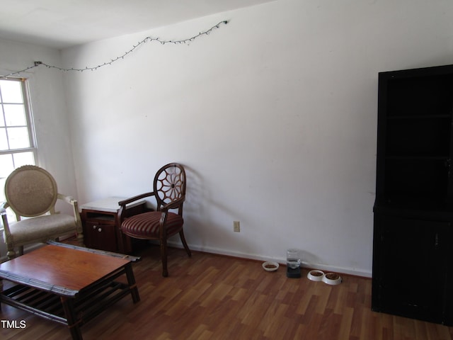 sitting room with wood finished floors and baseboards