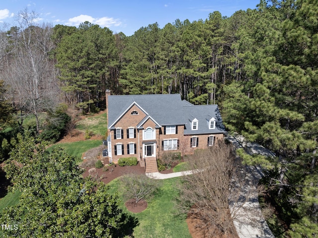 birds eye view of property featuring a wooded view