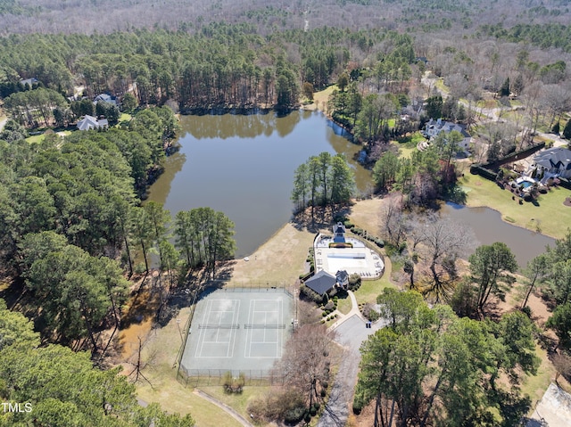 bird's eye view featuring a wooded view and a water view