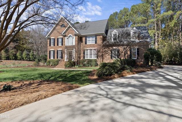 view of front of property with brick siding and a front lawn