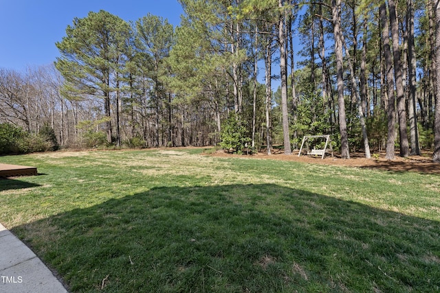 view of yard with a view of trees