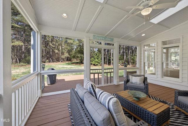 sunroom featuring ceiling fan and vaulted ceiling