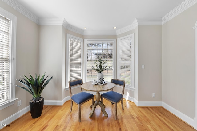 dining room with ornamental molding, recessed lighting, baseboards, and light wood-type flooring