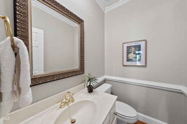 half bath featuring toilet, ornamental molding, and vanity