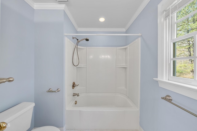 bathroom with toilet, crown molding, and  shower combination