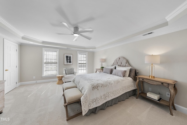 bedroom with a tray ceiling, baseboards, visible vents, and light carpet