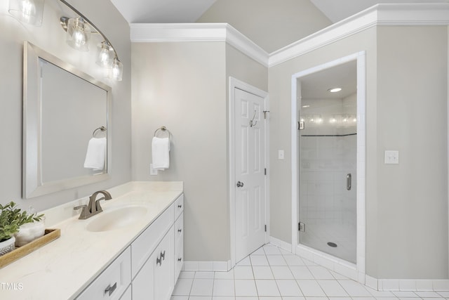 bathroom with tile patterned flooring, a shower stall, crown molding, baseboards, and vanity