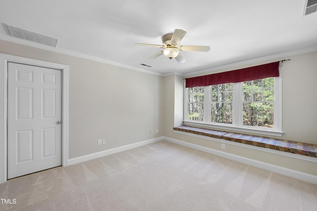 unfurnished room featuring visible vents, baseboards, light colored carpet, and ornamental molding