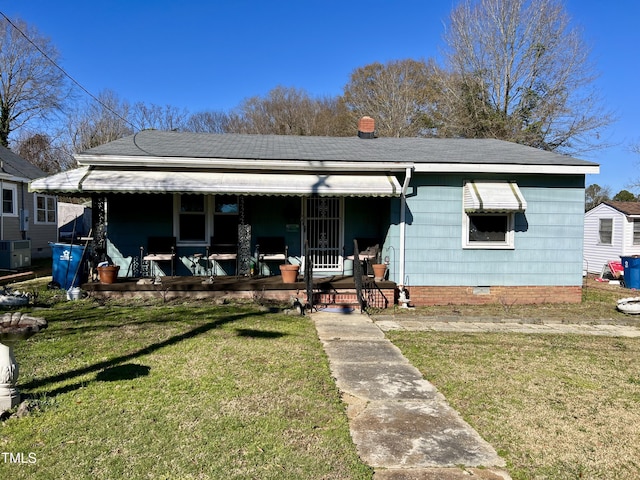 bungalow with a porch, central AC, and a front yard