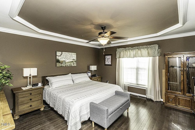 bedroom featuring crown molding, ceiling fan, dark hardwood / wood-style flooring, and a raised ceiling