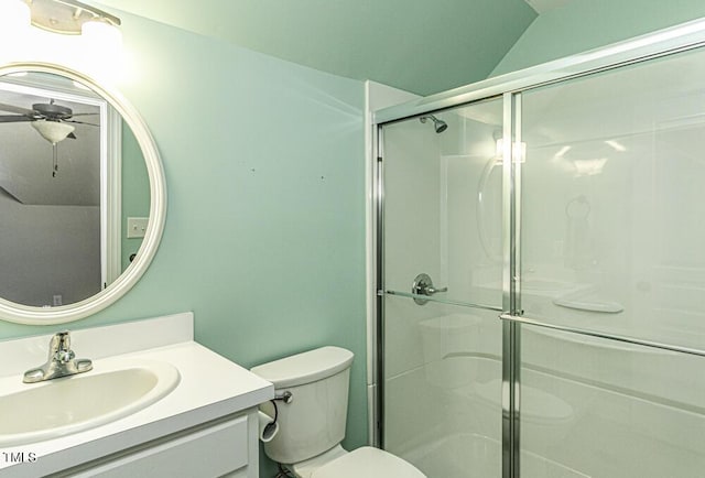 bathroom featuring vanity, ceiling fan, a shower with shower door, and toilet