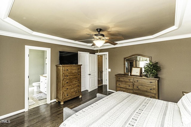 bedroom featuring crown molding, dark wood-type flooring, ensuite bath, ceiling fan, and a raised ceiling