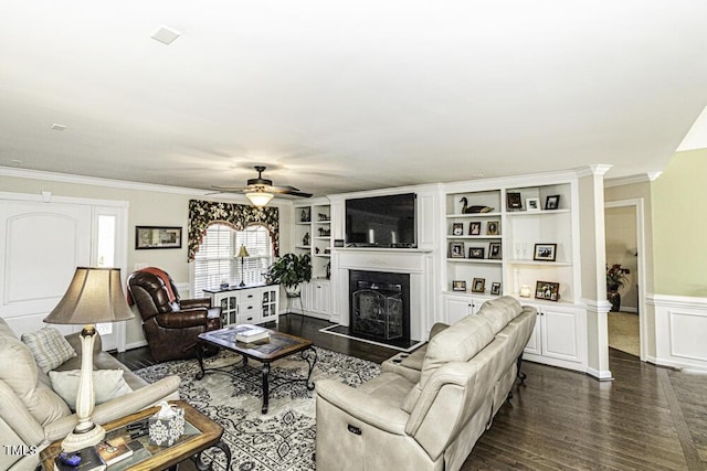 living room with ornamental molding, dark hardwood / wood-style floors, and ceiling fan