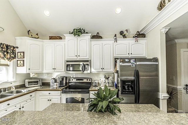 kitchen featuring tasteful backsplash, white cabinetry, sink, stainless steel appliances, and crown molding