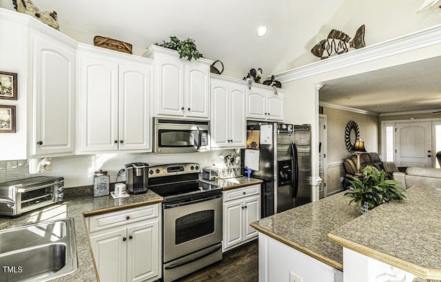 kitchen featuring white cabinetry, ornamental molding, and appliances with stainless steel finishes