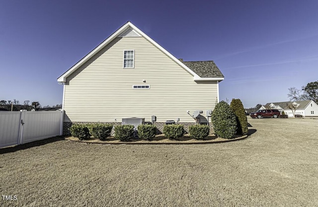 view of home's exterior featuring a yard and cooling unit