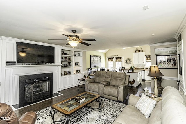 living room featuring dark wood-type flooring, ceiling fan, and vaulted ceiling