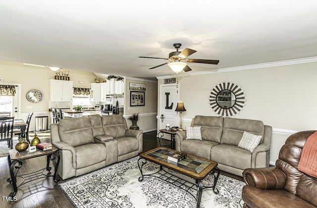 living room featuring crown molding, wood-type flooring, and ceiling fan