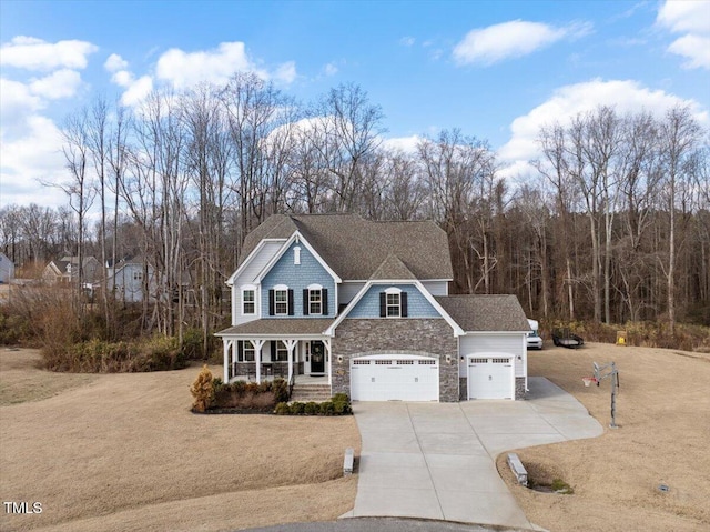 view of property with a garage and covered porch