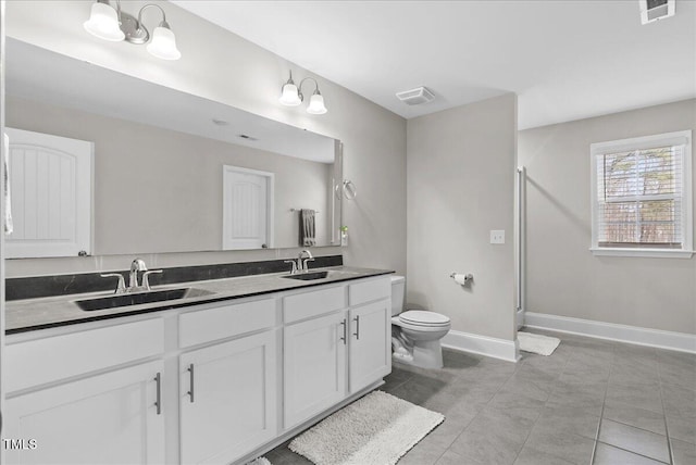 bathroom with tile patterned flooring, vanity, an inviting chandelier, and toilet