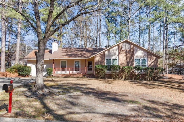 ranch-style home featuring a garage and covered porch