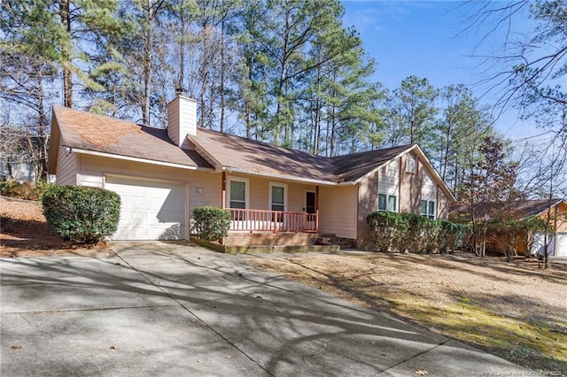 ranch-style house with a garage and a porch