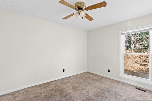 carpeted empty room featuring ceiling fan