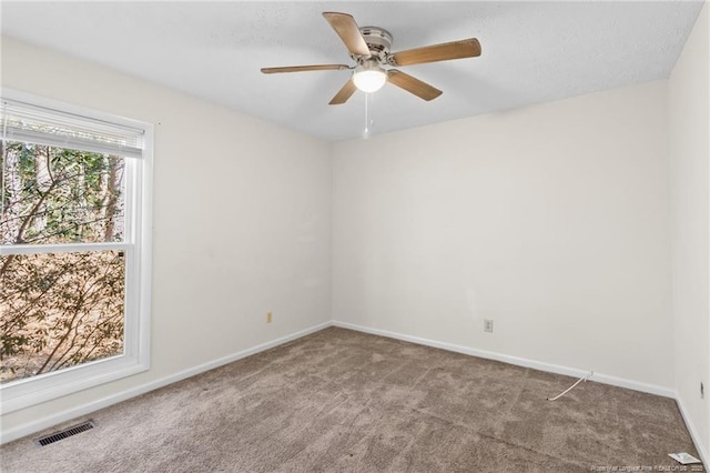 carpeted spare room featuring ceiling fan