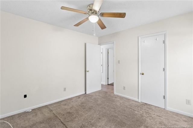 unfurnished bedroom with ceiling fan and carpet flooring