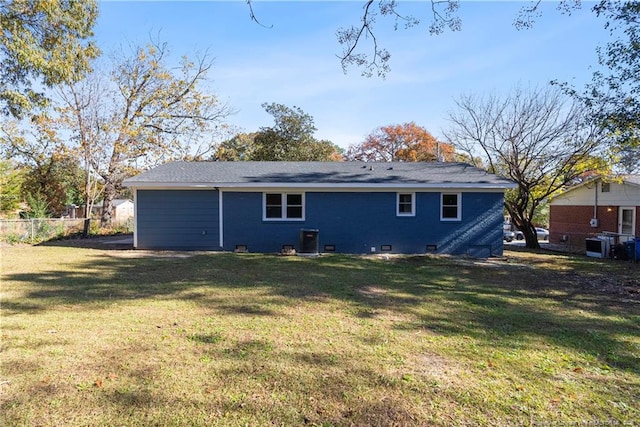 rear view of house featuring a yard and central AC