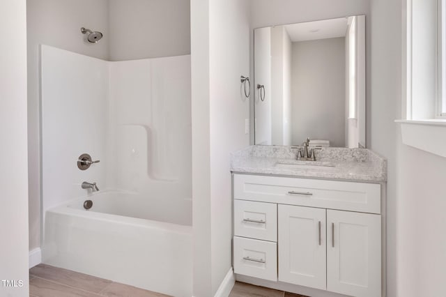 bathroom with vanity and bathtub / shower combination