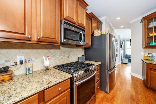 kitchen with stainless steel appliances, brown cabinets, glass insert cabinets, and light stone counters