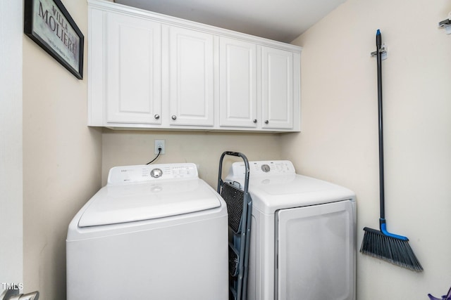 laundry area with washing machine and dryer and cabinet space