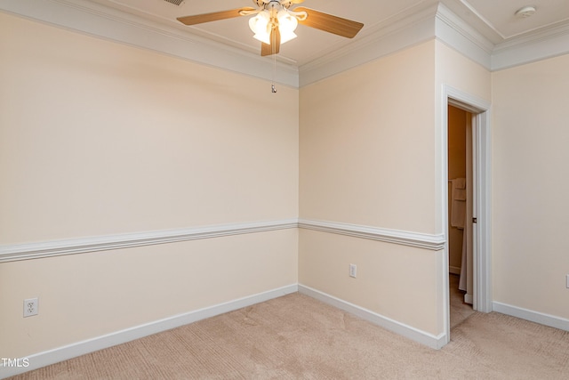 spare room featuring crown molding, ceiling fan, and light carpet