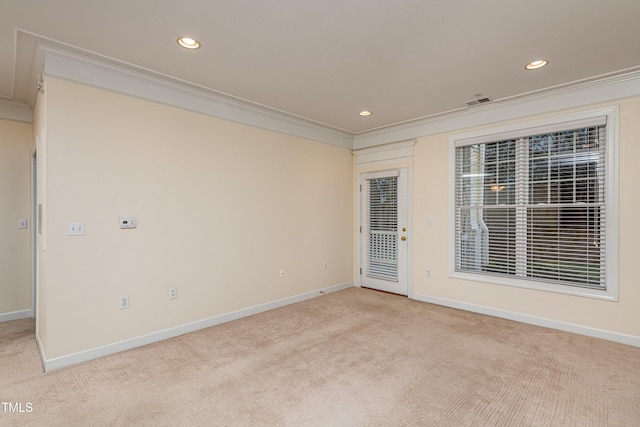 unfurnished room featuring ornamental molding and light colored carpet