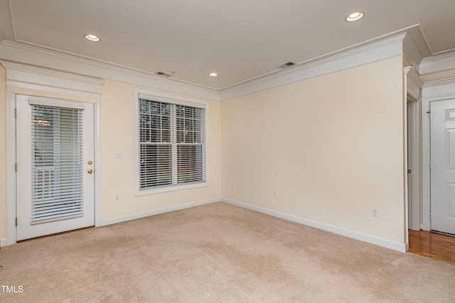 carpeted empty room featuring ornamental molding