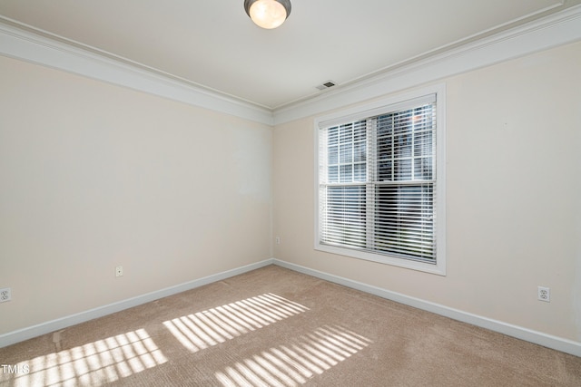 carpeted spare room with crown molding