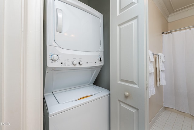 washroom featuring stacked washing maching and dryer, ornamental molding, and light tile patterned floors