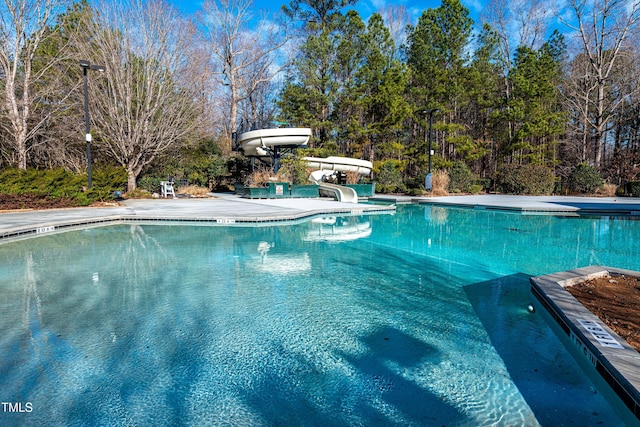 view of swimming pool with a water slide