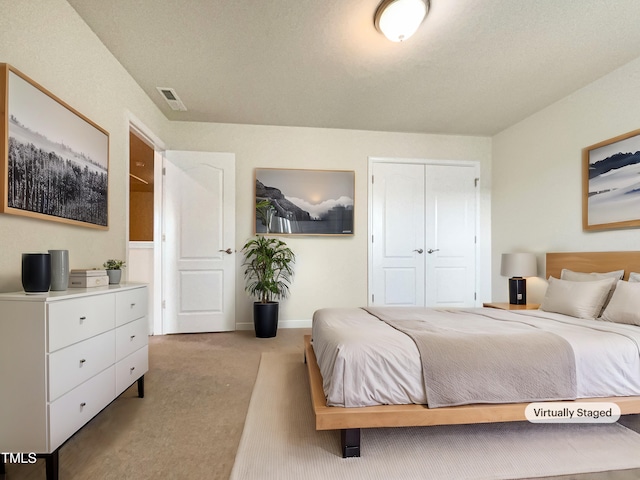 carpeted bedroom featuring a closet