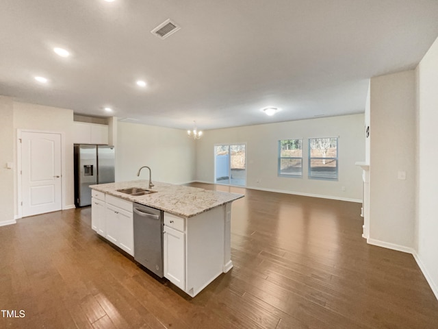 kitchen featuring stainless steel appliances, white cabinetry, a kitchen island with sink, and sink