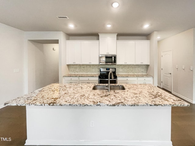 kitchen featuring white cabinetry, sink, stainless steel appliances, and a spacious island