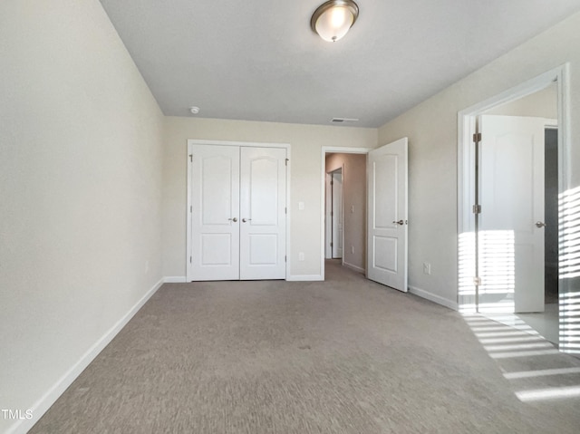 unfurnished bedroom with a closet and carpet