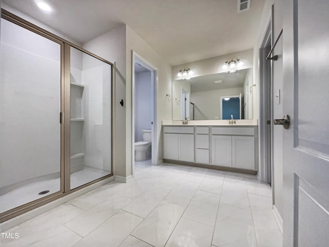 bathroom featuring vanity, an enclosed shower, and toilet