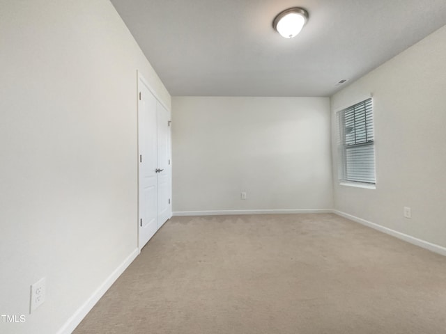 empty room featuring light carpet